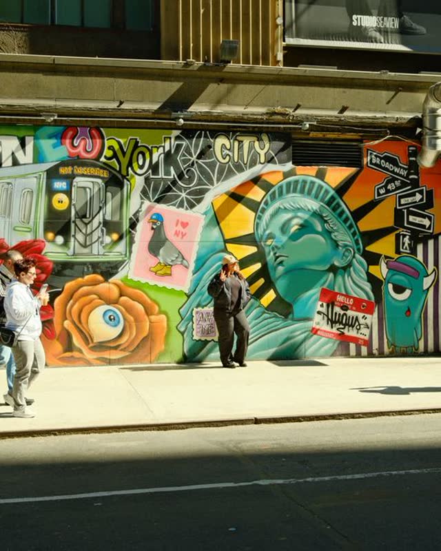 People walking past street art in New York