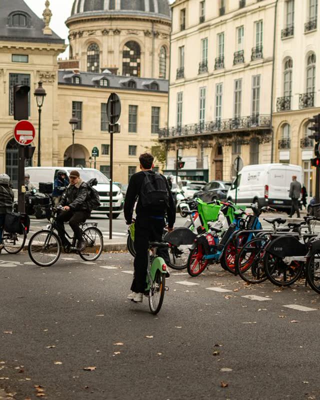 People cycling down a Paris street